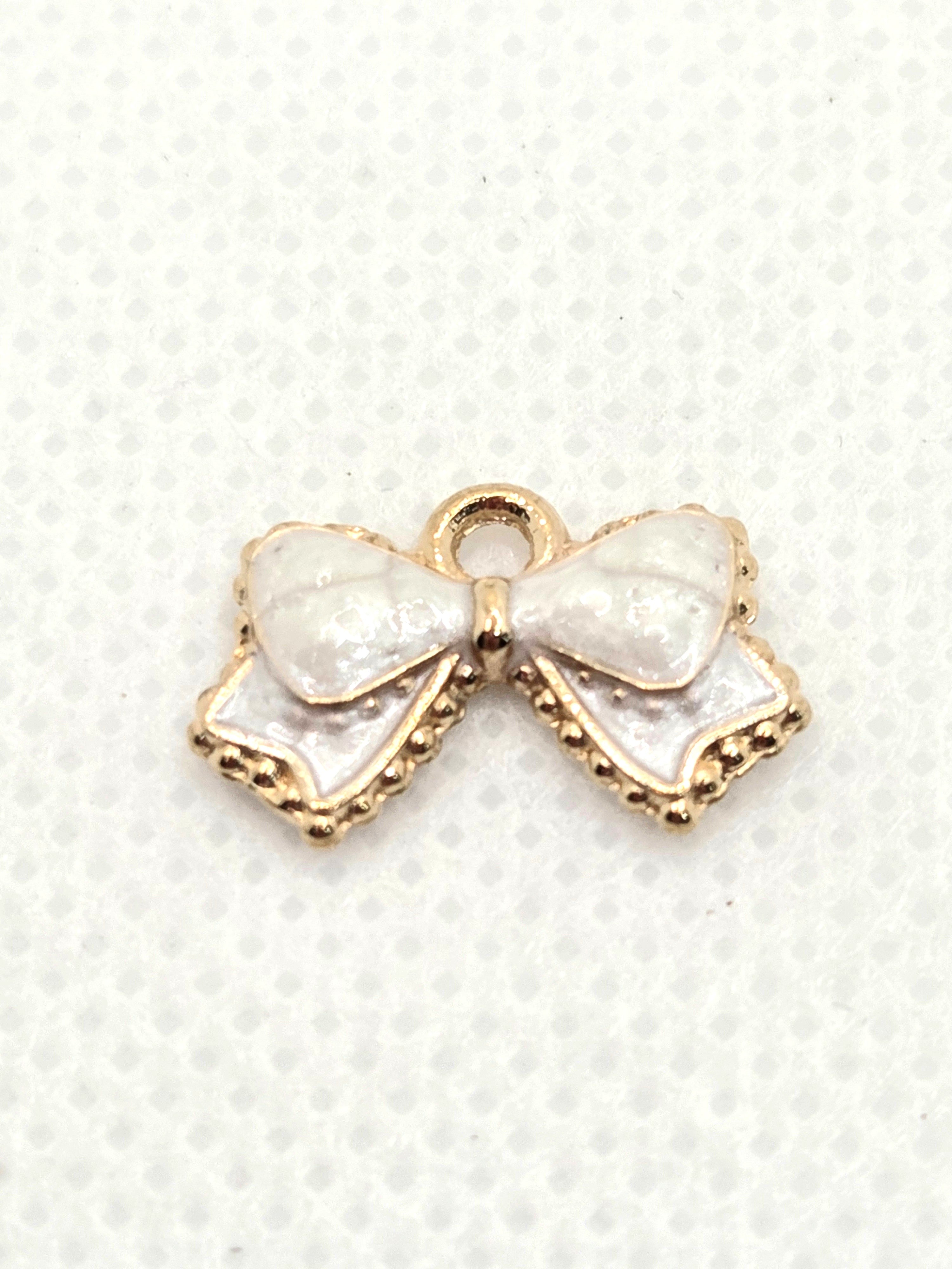 Pearlized White Bow Etched in Gold Dangle